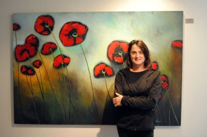 Alison Fowler at her studio in front of one of her poppy paintings, “All That We Perceive,” which was up for sale at Pop-Up Gallery Ottawa. [Photo © Lesley LeRoux]