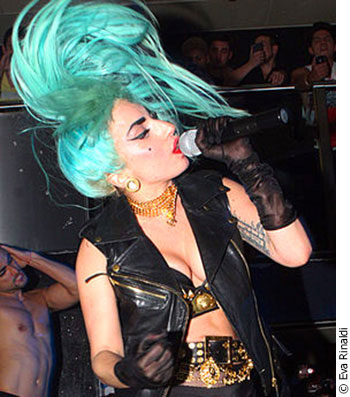 Lady Gaga performing in a turquoise wig.