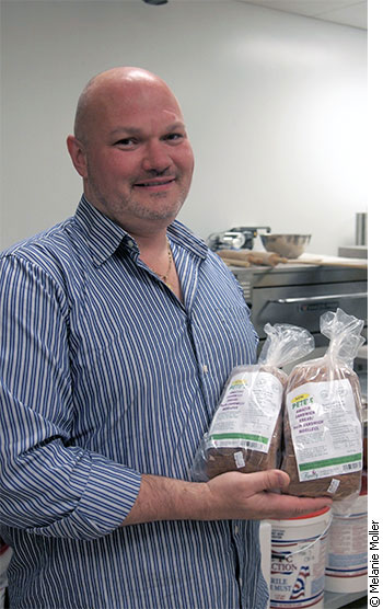 Baker Peter de Hoog stands with a load of his best-selling gluten-free "Amazing Sandwich Bread"