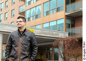 Kevin Starkgraff, 20, stands in front of his apartment building at Park Ridge Place. He and his family recently moved there, downsizing from a single-detached home. 