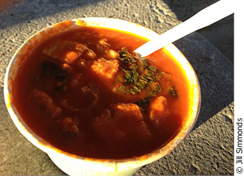 A cup of Stone Soup Food Works' homemade tomato and kale soup