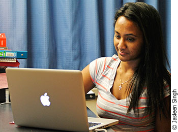 Natasha Gnanam, a third-year law student at Carleton is checking out the “Spotted at Carleton U” Facebook page on her laptop. 