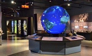An interactive globe allows visitors to enact different scenarios using controls. 