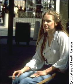 woman smoking on bench