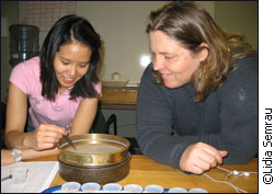 Lily Visanuvimol and Dr. Susan Bertram analyze cricket eggs.