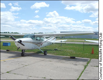 This is an image of a private aircraft. It sits in the runway at the Rockcliffe Flying club on a sunny day