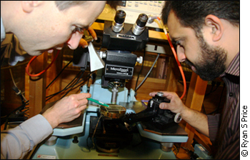 Langis Roy, chair of the department of electronics at Carleton University, and PhD student Atif Shamim analyze a wireless transmitter chip inside a radio-interference insulated room.